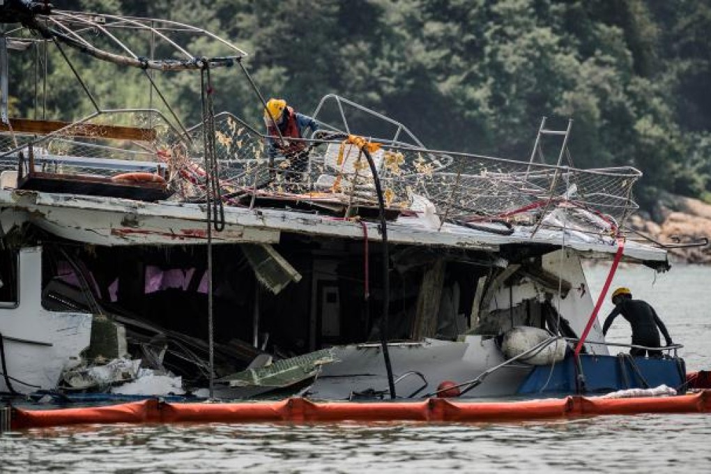 Firemen inspect the back end of the badly damaged Lamma IV passenger boat, near Lamma island on October 3, 2012. Photo: AFP