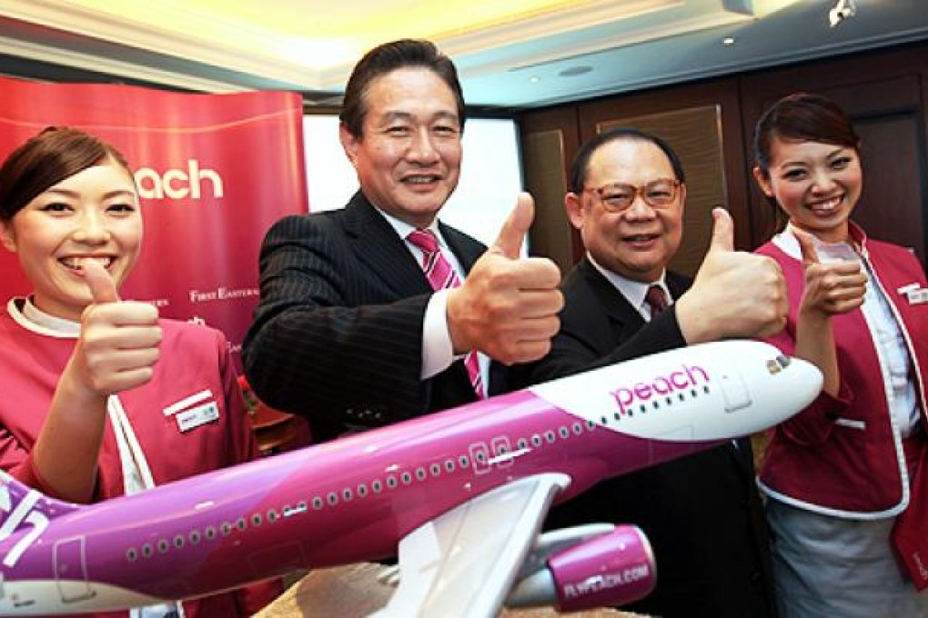 Peach Aviation chief Shinichi Inoue (second left) and First Eastern Investment chairman Victor Chu in June. Photo: Jonathan Wong