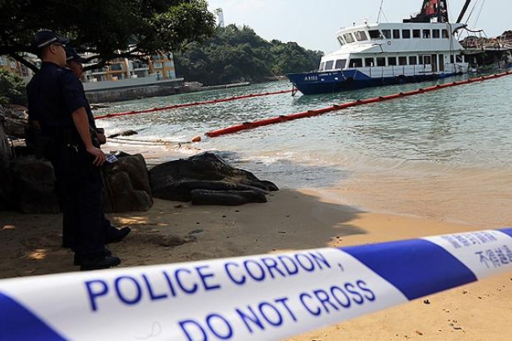 A police cordon surrounds the wrecked hull of the Lamma IV. Photo: David Wong