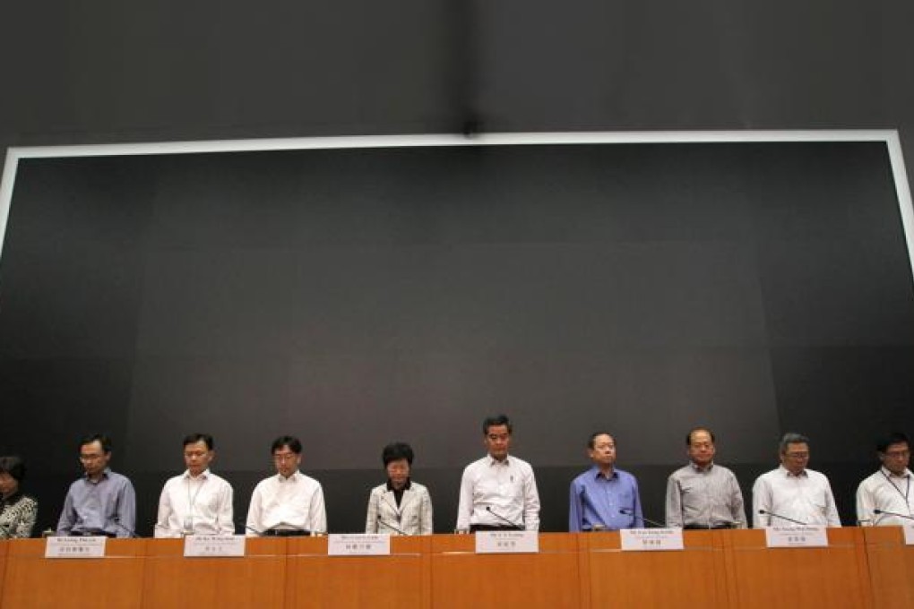 Chief Executive Leung Chun-ying leads a moment of silence for victims of the tragedy before a press conference yesterday. Photo: Nora Tam
