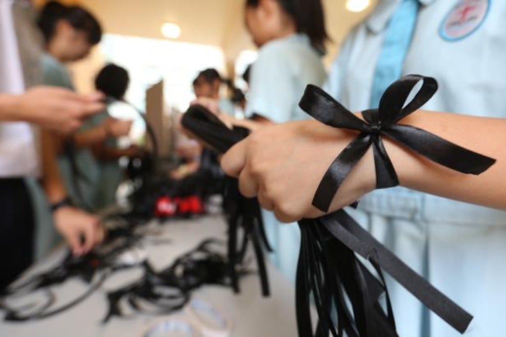 Students mourning the deceased at CNEC Lau Wing Sang Secondary School where two students drowned at Shek O Beach. Photo: Sam Tsang