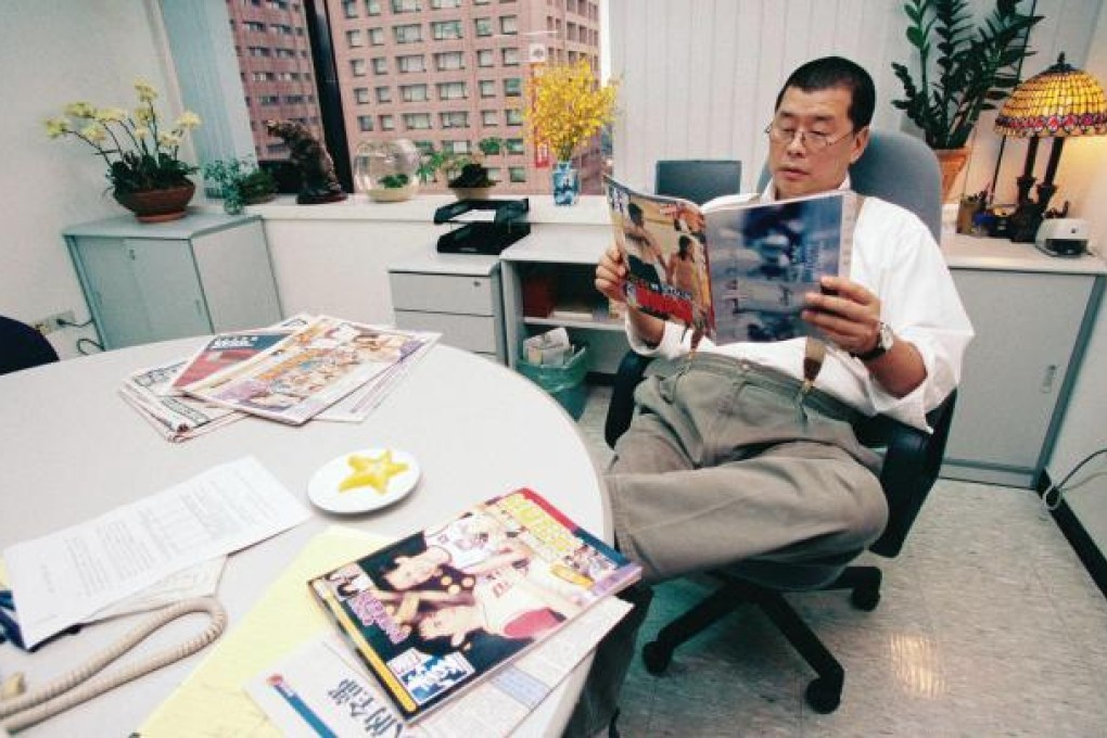 Next Media boss Lai Chee-ying reads Next Magazine in his Taipei office. Lai has sold his TV business there. Photo: Apple Daily