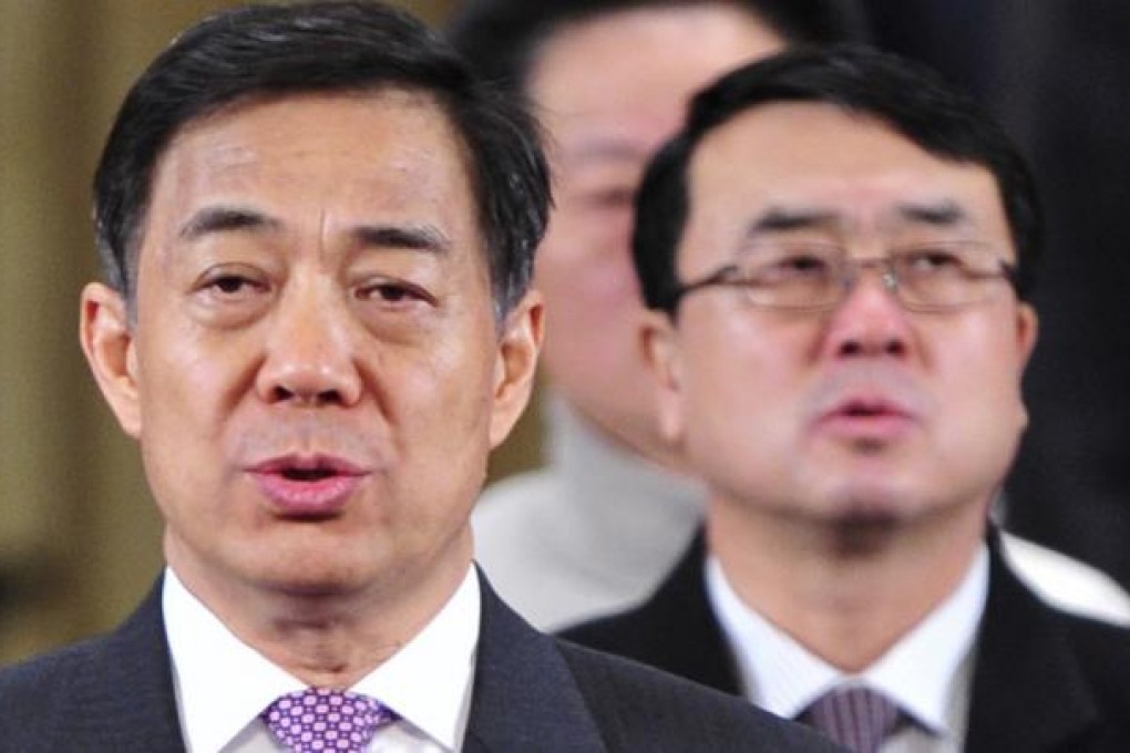 Former Chongqing Party Secretary Bo Xilai (L) and Deputy Mayor Wang Lijun (R) sing the national anthem during a conference in Chongqing in this January 7, 2012 file photo. Photo: REUTERS