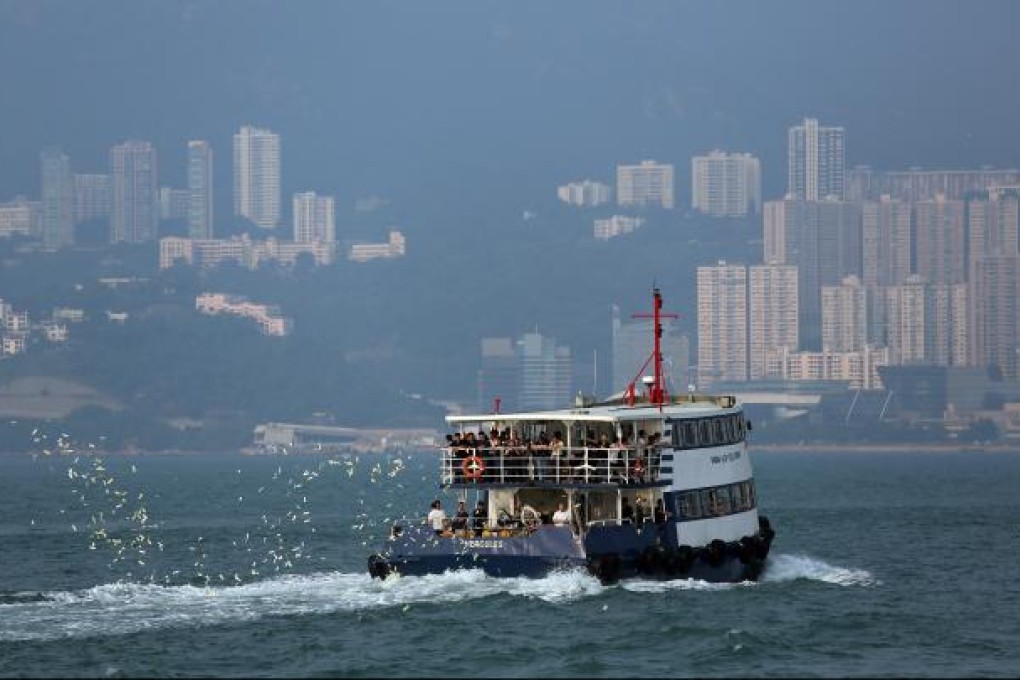 Relatives of victims who died in the October 1 ferry collision throw paper offerings to mourn the dead from a boat at the site of the accident in Hong Kong on October 4, 2012. Photo: EPA