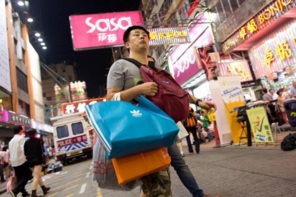 A shopper holds multiple shopping bags in Causeway Bay during the October 1 "Golden Week" in Hong Kong. Photo: SCMP
