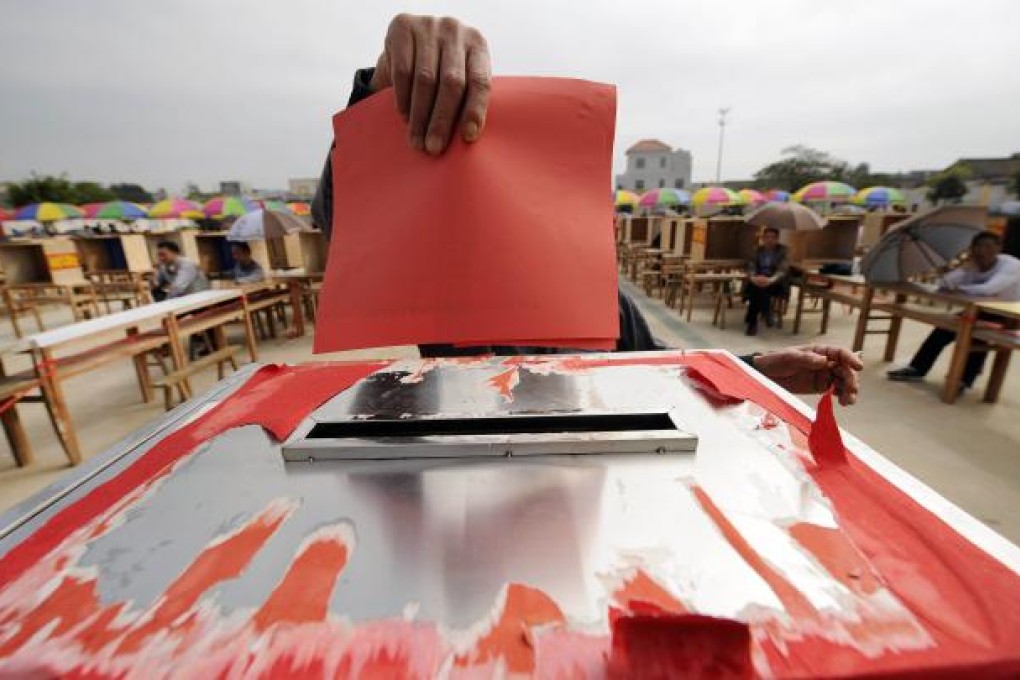 A resident casts his vote on the second day of village elections in Wukan in China's southern Guangdong province on March 4, 2012. Photo: AFP