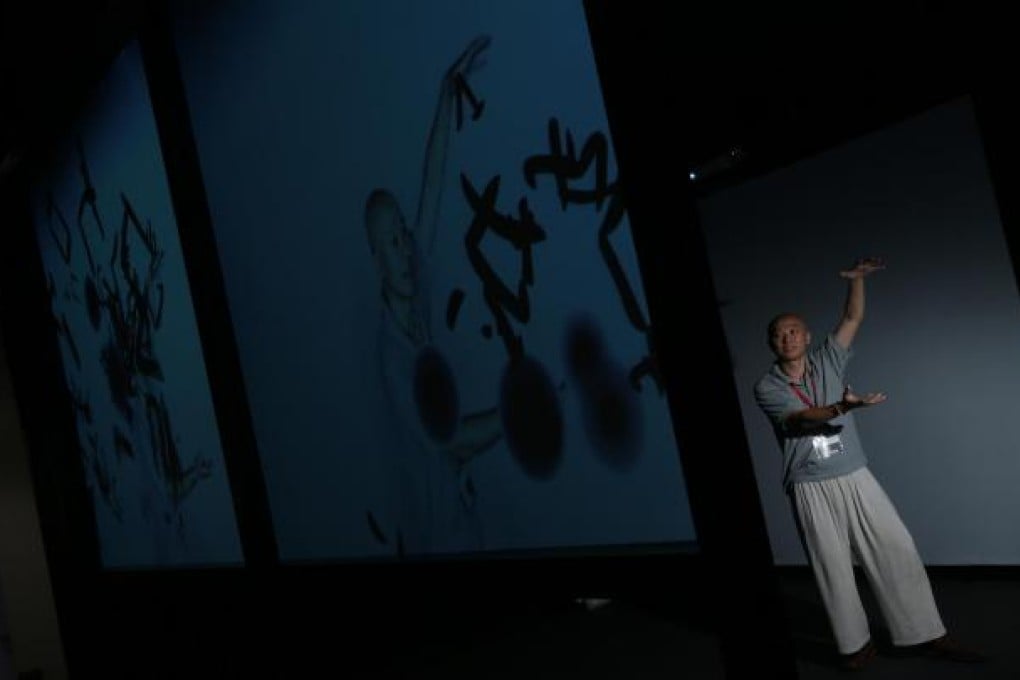 Hong Kong artist Hung Keung at his interactive video installation at Fine Art Asia. Photo: Sam Tsang