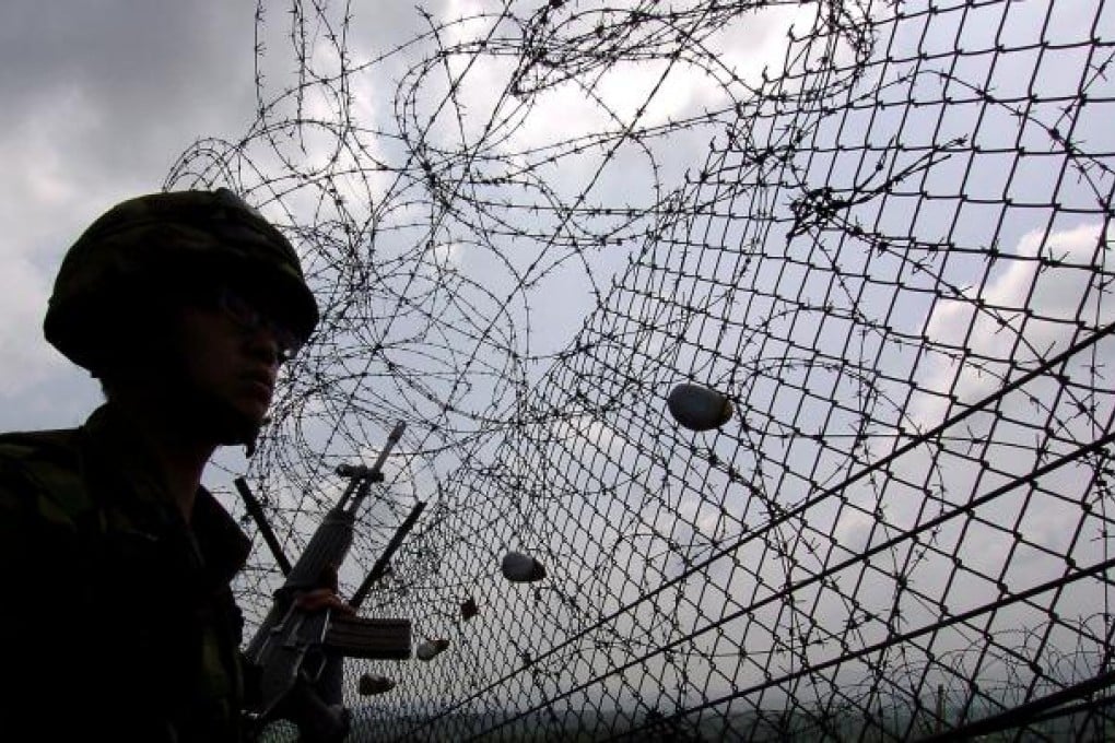 South Korean soldiers patrolling along the barbed wire fence near an observation point, on the southern side of the demilitarised zone (DMZ), in Paju. Photo: AFP