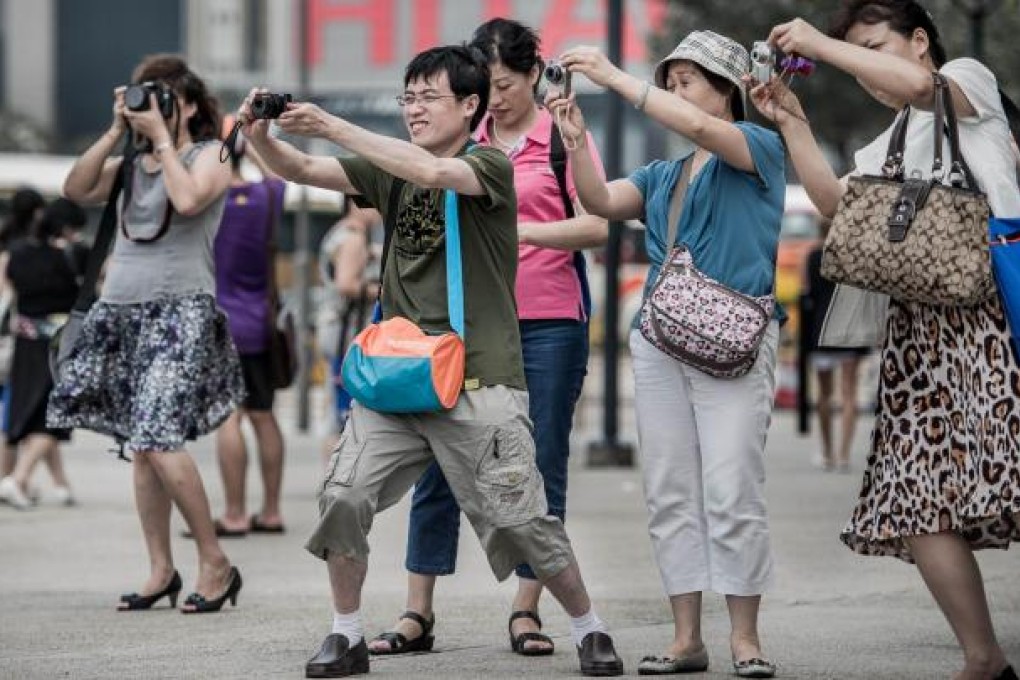 Mainland online travel agencies are fighting fiercely for the growing tourism market by offering cash rebates to customers. Photo: AFP