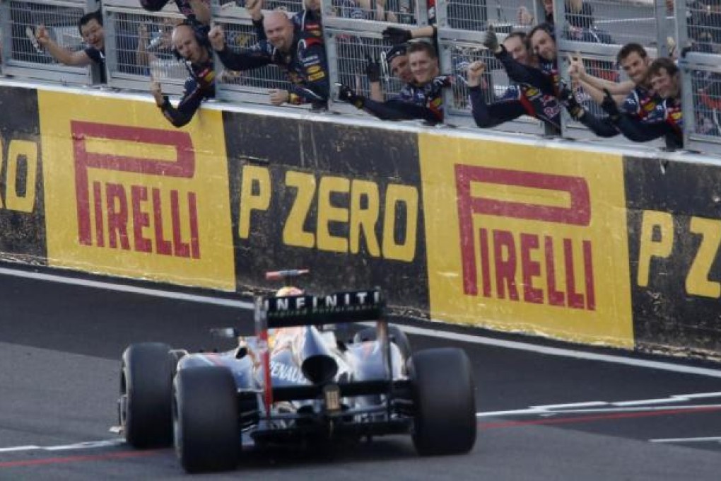 Red Bull mechanics celebrate the victory of Sebastian Vettel of Germany at the end of the Japanese Grand Prix yesterday. Photo: Reuters
