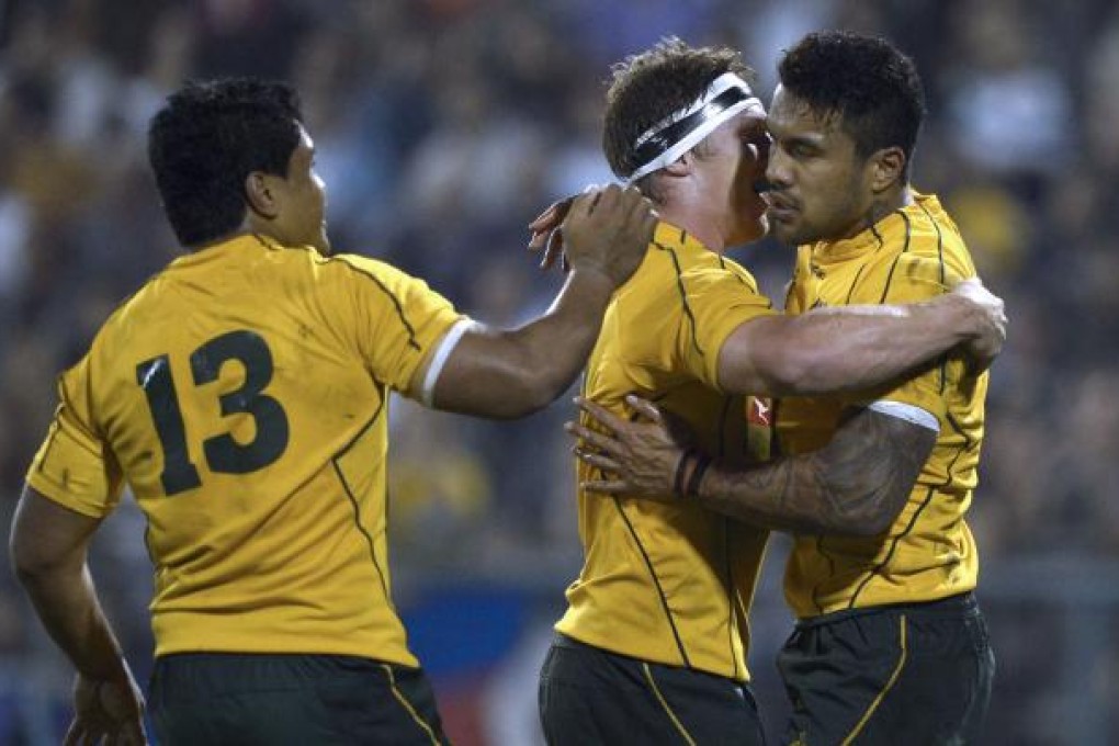 Australian Wallabies' wing Digby Ioane (right) celebrates with teammates Michael Hooper (centre) and Ben Tapuai. Photo: AFP