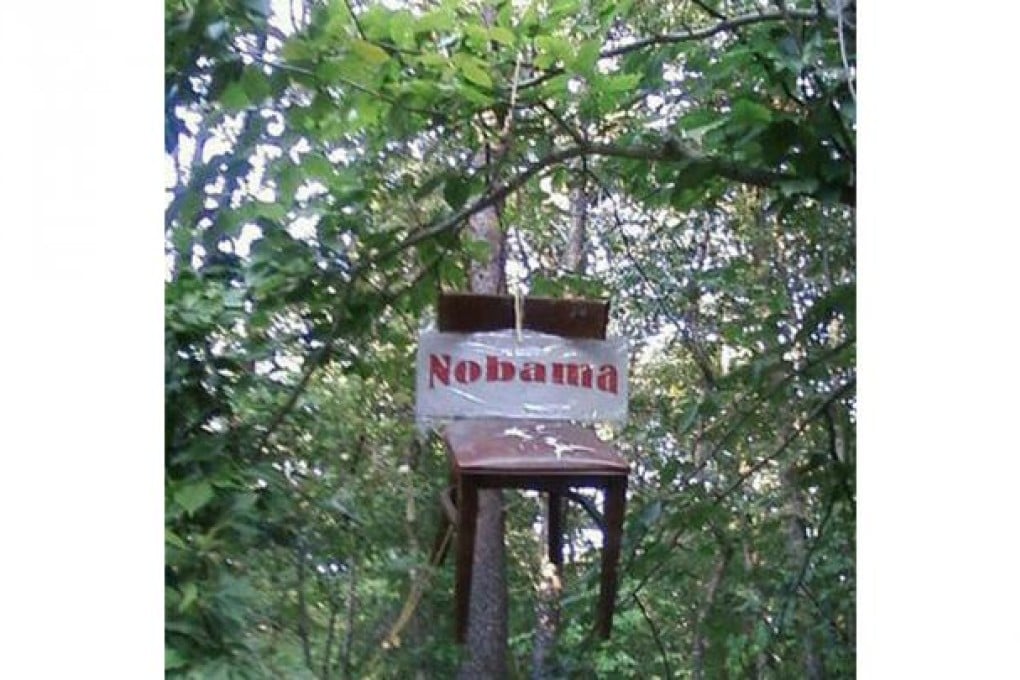 An empty chair reading 'Nobama' is strung from a tree by disgruntled American voters.