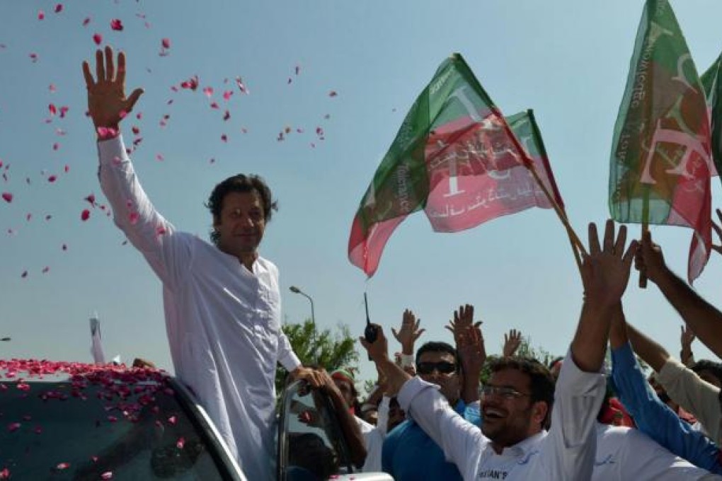 Imran Khan waves to supporters in Islamabad at the start of the rally to Pakistan's tribal belt in protest at US drone attacks. Photo: AFP