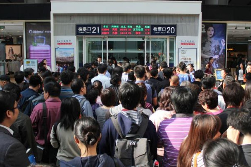 Passengers wait to board trains at the Beijing South Railway Station yesterday as they return home after the long holiday. Photo: Xinhua