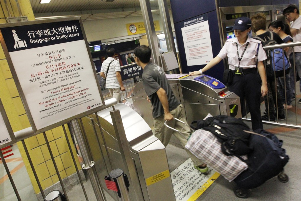 A notice reminds passengers about the new 32kg weight limit on the East Rail Line at the Sheung Shui MTR station. Photo: Nora Tam