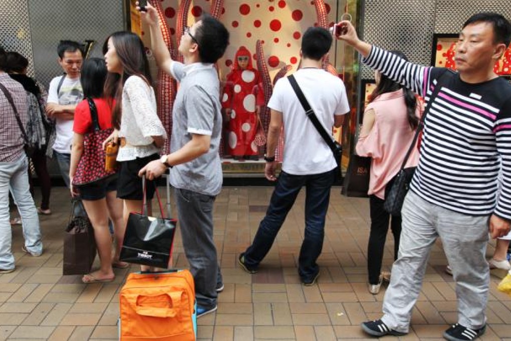 Mainland visitors overwhelm shopping districts like Tsim Sha Tsui.