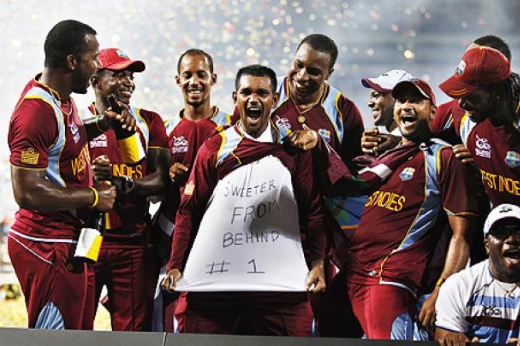 West Indies' cricketer Denesh Ramdin (centre) celebrates with teammates in Colombo, Sri Lanka, on Sunday. Photo: AP
