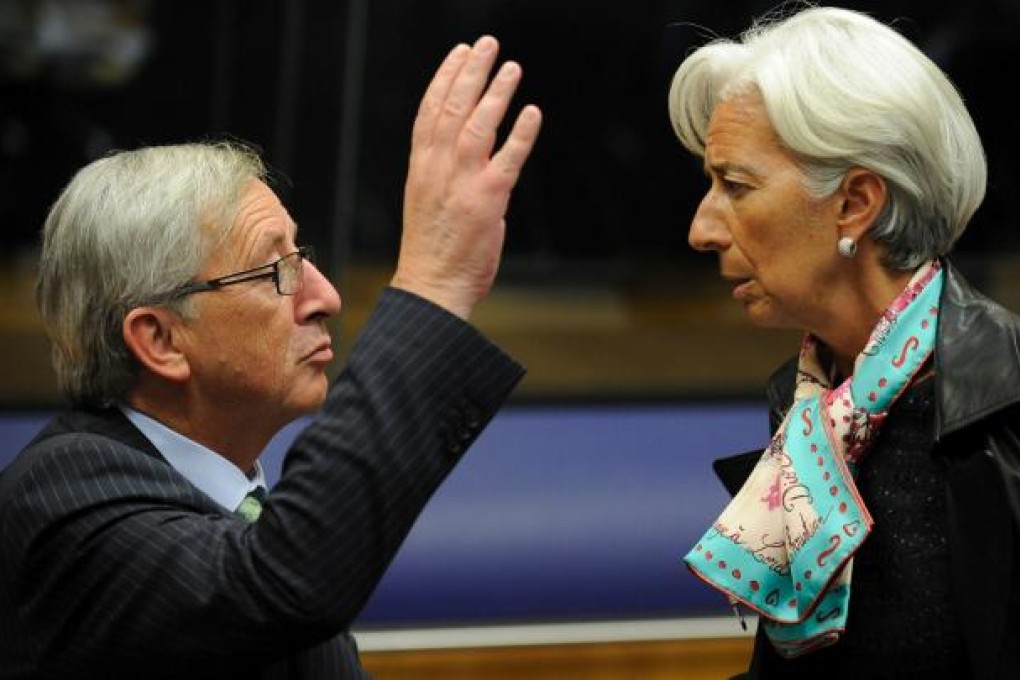 Prime Minister and President of the Eurogroup Council Jean-Claude Juncker (left) speaks with IMF chief Christine Lagarde (right) before an Eurogroup Council meeting. Photo: AFP