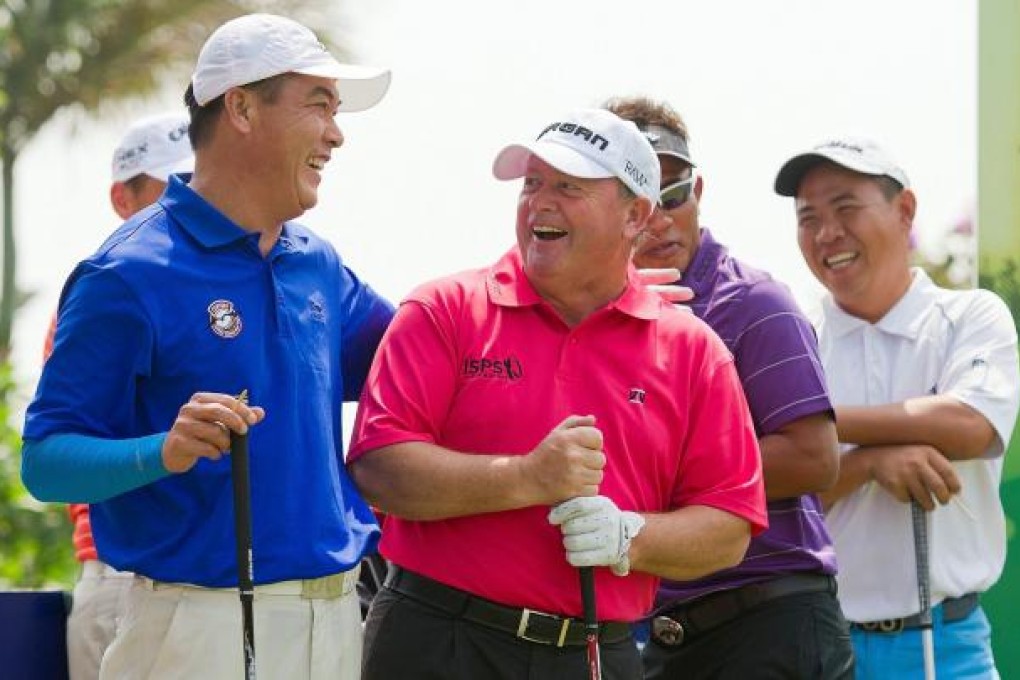 China's Zhang Lianwei and Ian Woosnam share a joke as Taiwan's Chen Yih-shin and Thongchai Jaidee of Thailand look on. Photo: AFP