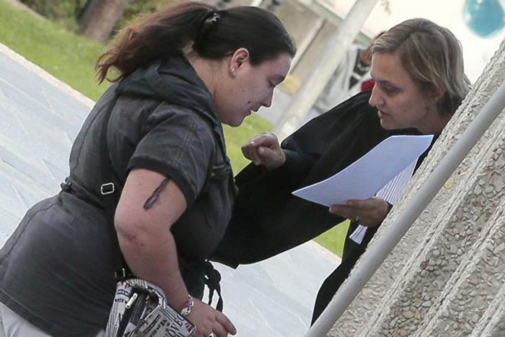 An alleged victim, Nina (left), talks to her lawyer outside the court at Creteil, near Paris. Photo: AFP