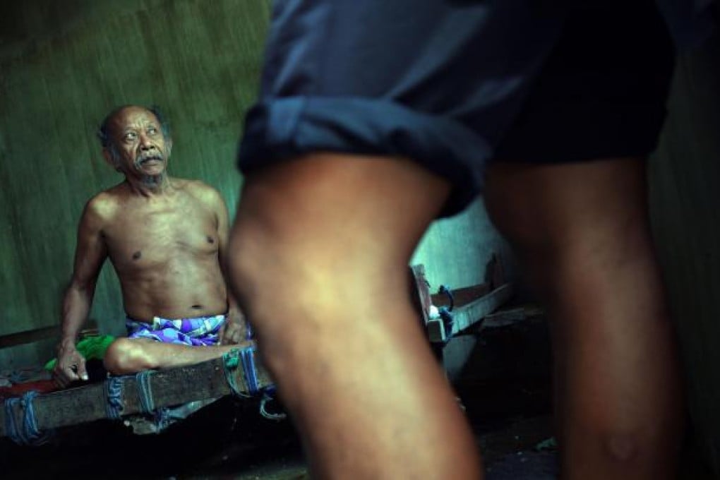 Nengah Surung, 65, a schizophrenic, is confined to his room in Karangasem district, where psychiatric treatment is underfunded. Photo: AFP