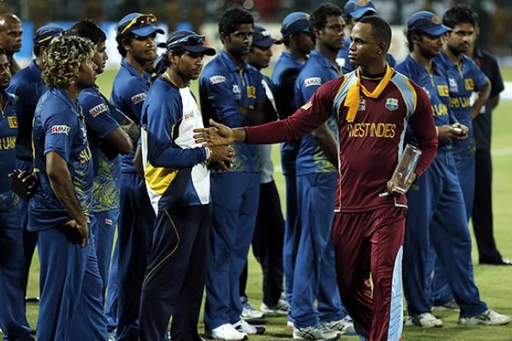 West Indies' cricketer Marlon Samuels greats Sri Lankan team members after winning the ICC Twenty20 Cricket World Cup in Colombo on Sunday. Photo: AFP