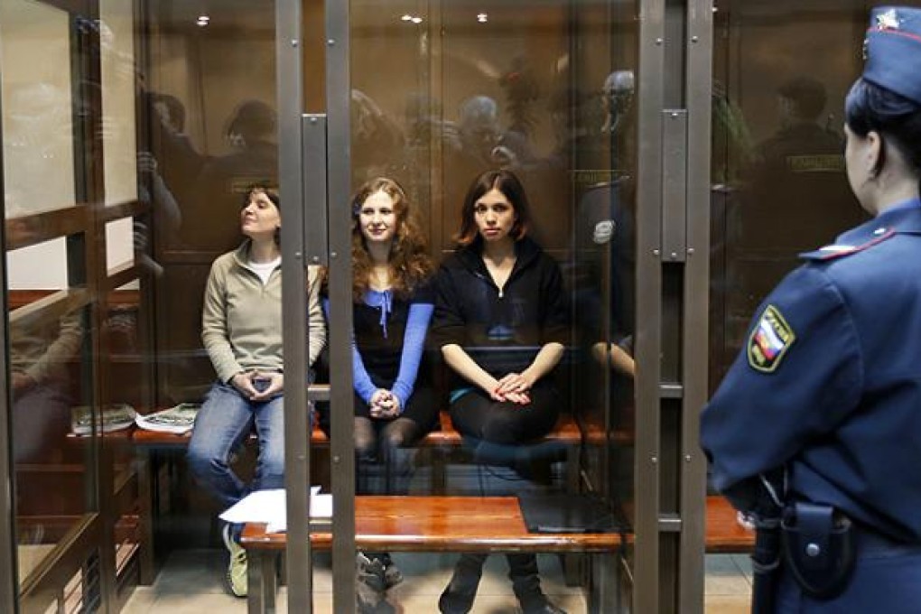 Pussy Riot members (from left) Maria Alekhina, Yekaterina Samutsevich and Nadezhda Tolokonnikova are held in Moscow court room on Wednesday. Photo: AP