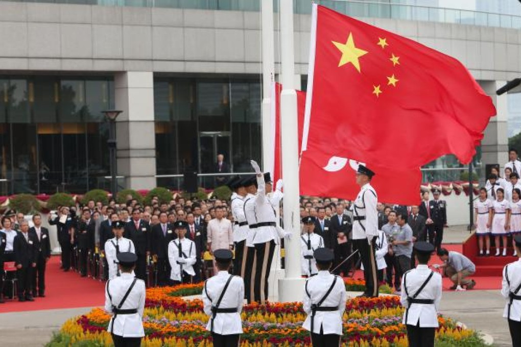 People attend a flag raising ceremony at the Golden Bauhinia Square in Hong Kong on Oct. 1, 2012. Photo: SCMP