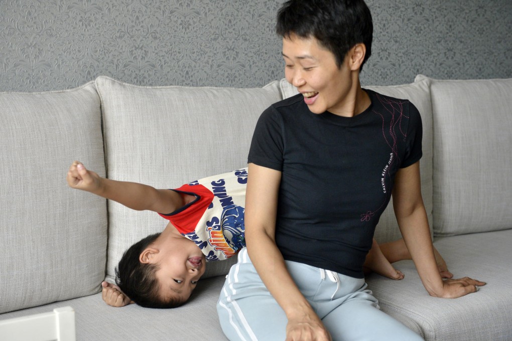 Kay Fung with son Markus. Fung says she doesn't try to protect Markus from tumbles and expects him to be responsible for his actions. Photo: Warton Li