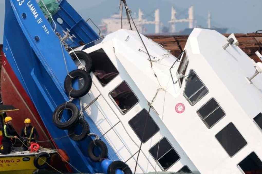 The boat Lamma IV that collided with a ferry in the water off Lamma Island is being lifted up from the sea on October 2, 2012. Photo: SCMP/Sam Tsang