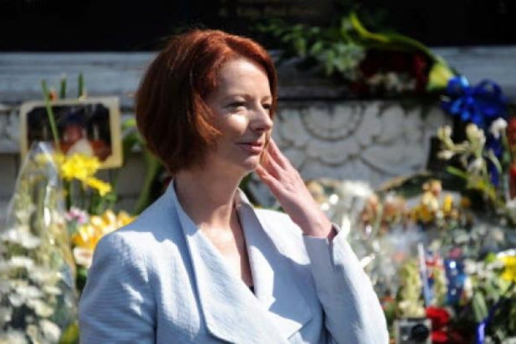 Australian Prime Minister Julia Gillard (right) visits the 2002 Bali Bombing memorial monument as she pay tribute to victims in Kuta, Bali, on Saturday. Photo: EPA