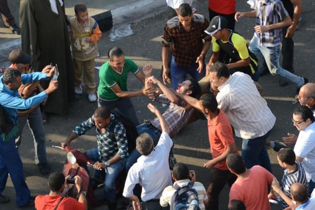 Supporters of Mohammed Mursi clash with liberal and leftist protesters in Cairo. Photo: AFP