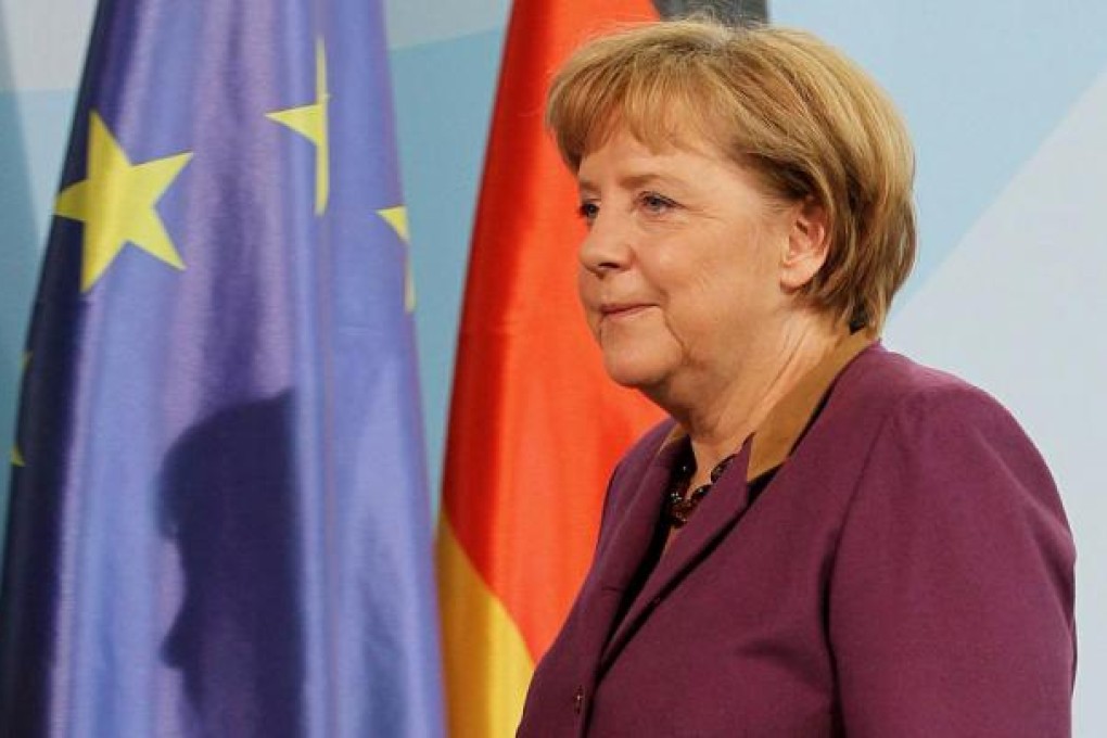 Angela Merkel prepares to deliver her statement on the Peace Prize. Photo: EPA