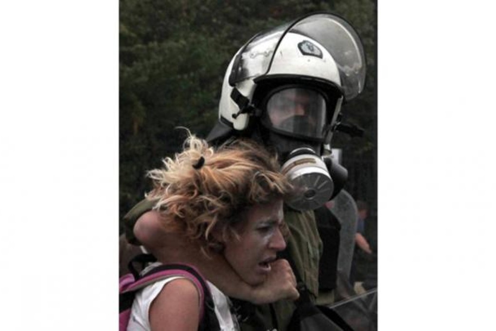 The officer with his arm around the distressed protester’s neck.