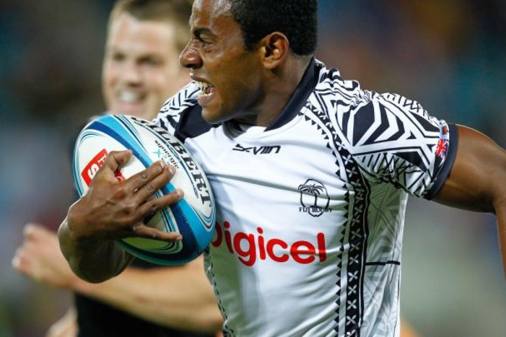 Fijian Ratu Raitini breaks the All Blacks defence. Photo: AFP