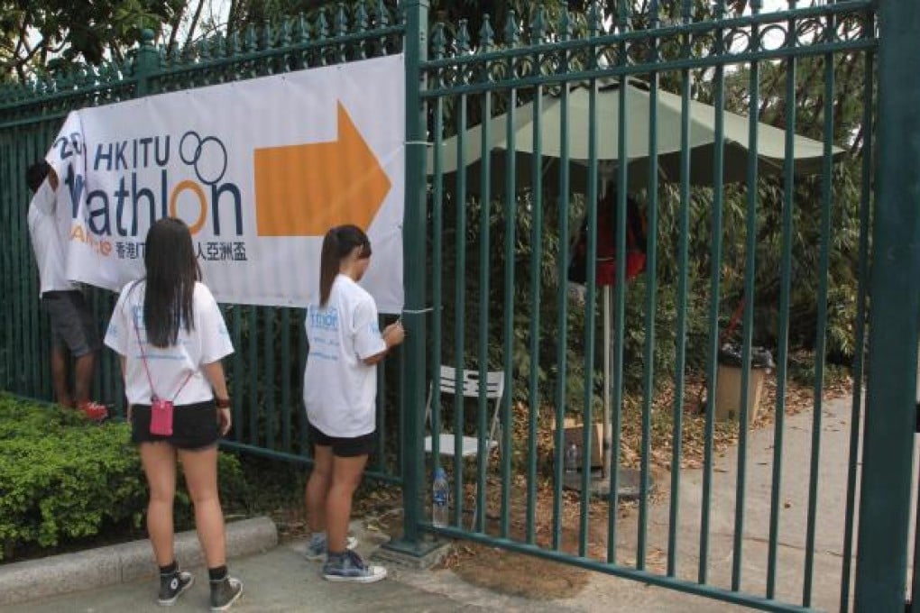 Staff take down banners after the race. Photo: SCMP