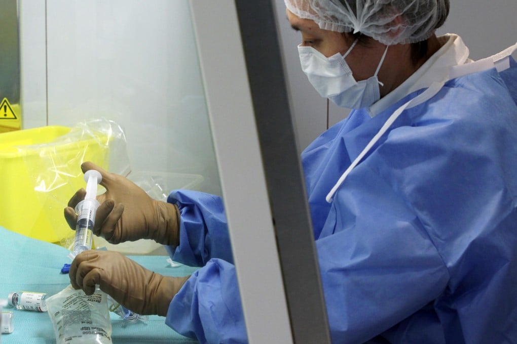 A pharmacist processing chemotherapy drugs in a safety cabinet. Photo: K.Y. Cheng