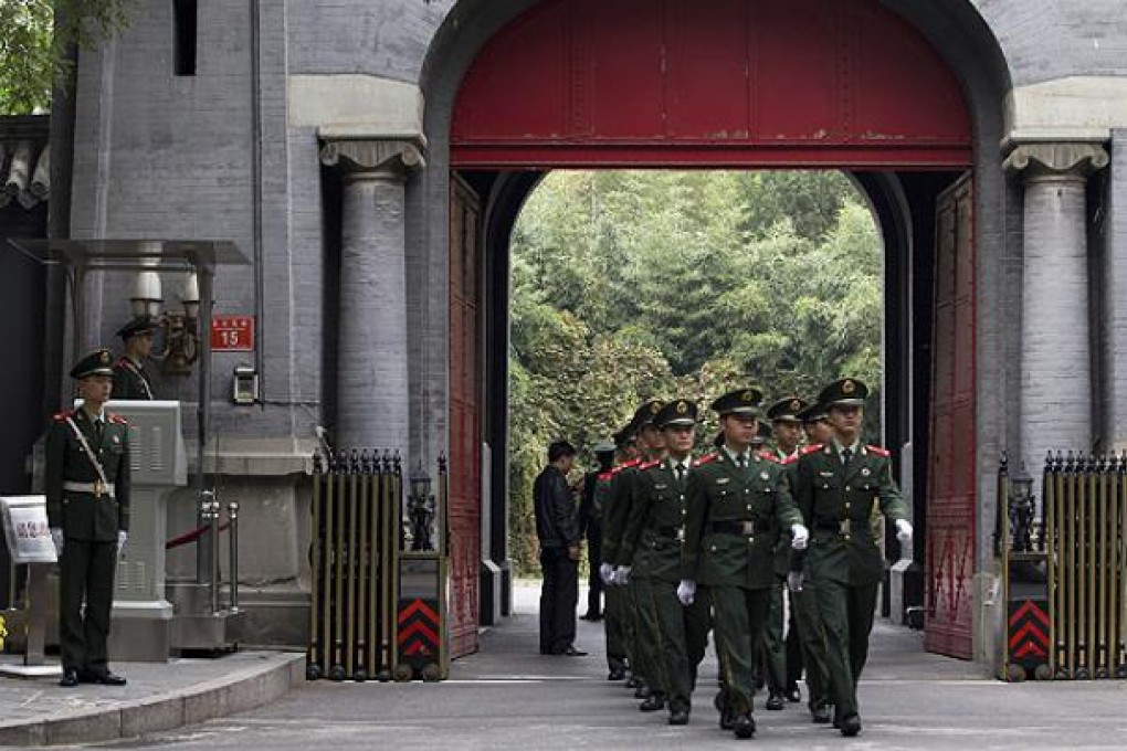 Paramilitary policemen march at the home of the former Cambodian king in Beijing. Photo: AP