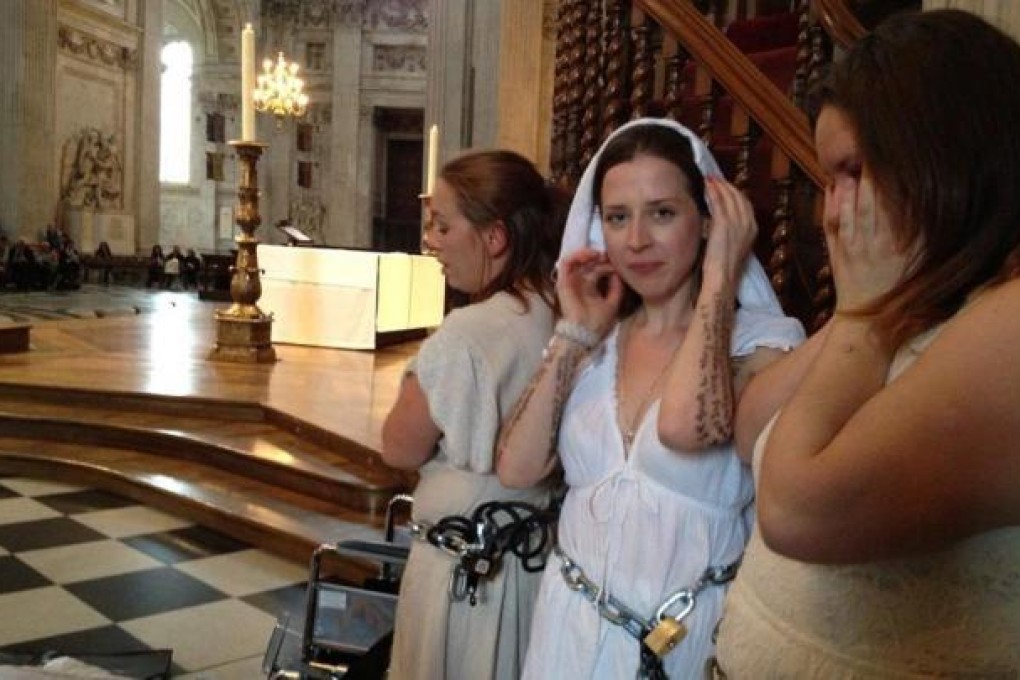 Women protesters chained to the St Paul's pulpit. Photo: EPA