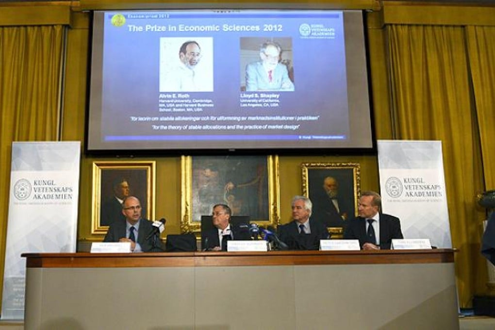 Staffan Normark of the Royal Swedish Academy of Sciences announces the winner of the Nobel Prize in Economic Sciences on Wednesday. Photo: AP
