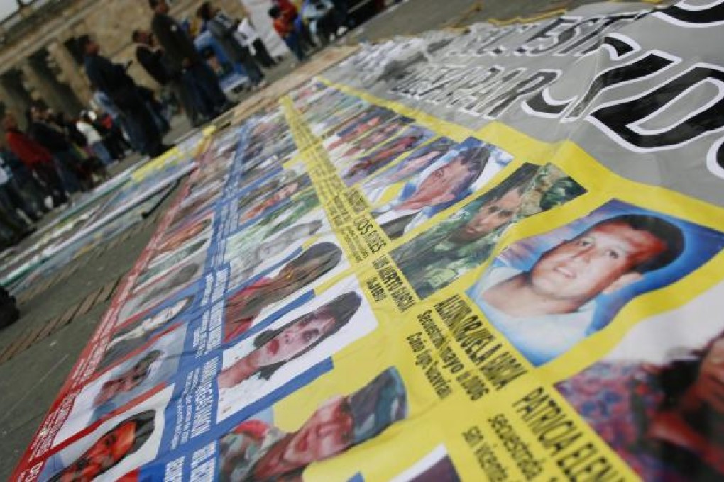 Relatives of victims kidnapped by Farc (pictured above) campaign against an amnesty for the rebels in the peace process. Photo: Reuters