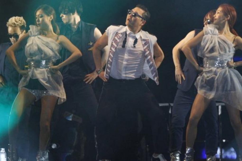 South Korean rapper Psy (centre) has topped the charts in the United States and Britain with Gangnam Style, which has brought massive exposure to K-Pop and introduced the wider world to the genre.