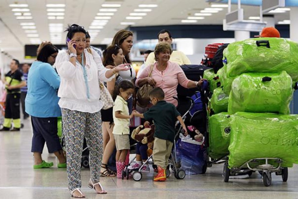 Passengers at Miami airport wait for a flight to Havana. Photo: AP