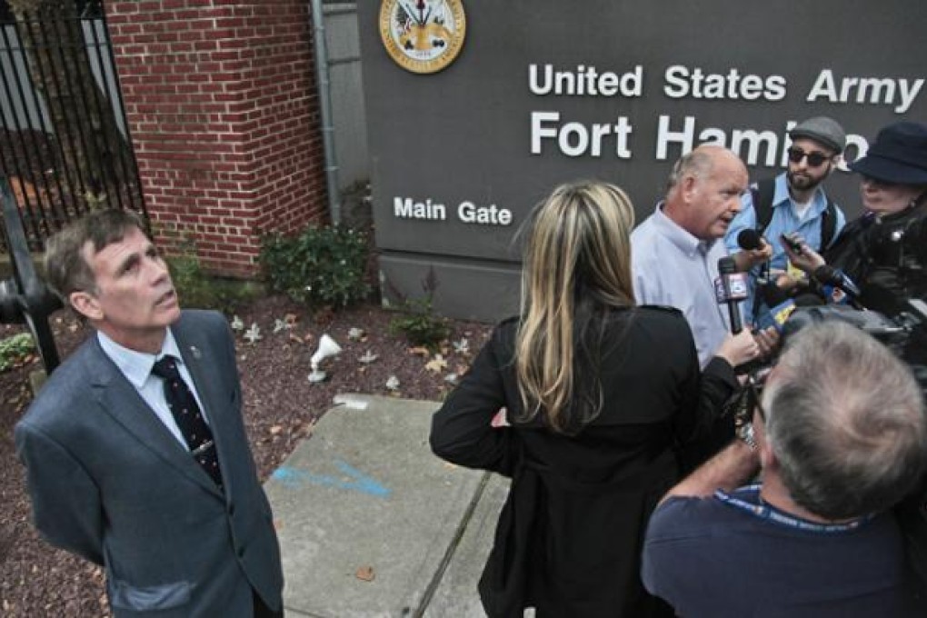 Robert Reeg (far left), a retired firefighter who was injured while responding to the September 11 attacks, listens as Ken Fairben (third from right), who lost his son Keith in the attacks, holds a press briefing on Monday. Photo: AP