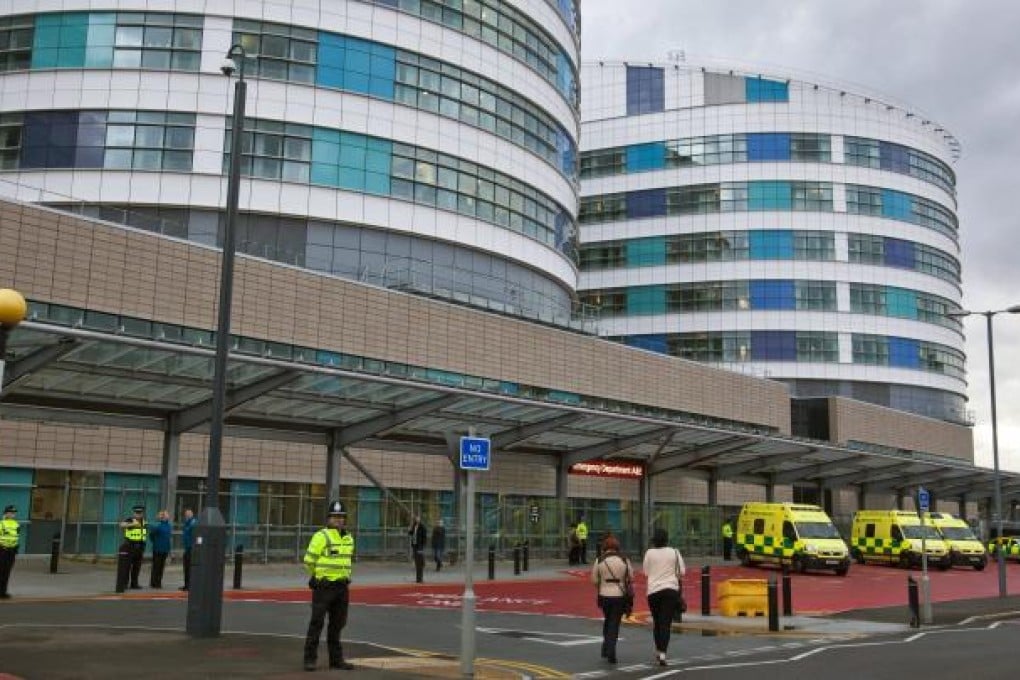 Police officers stand guard around the Queen Elizabeth Hospital in Birmingham where 14-year old Malala is being treated. Photo: EPA