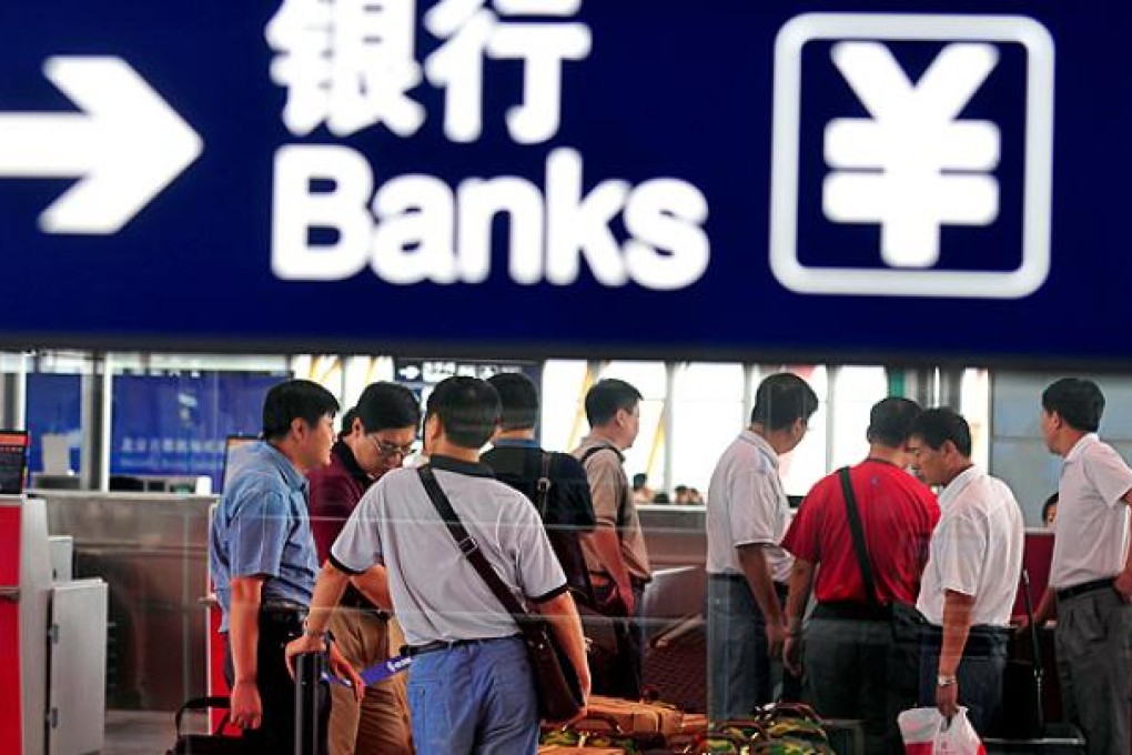 Travellers check-in baggage at Beijing international airport. Photo: AFP