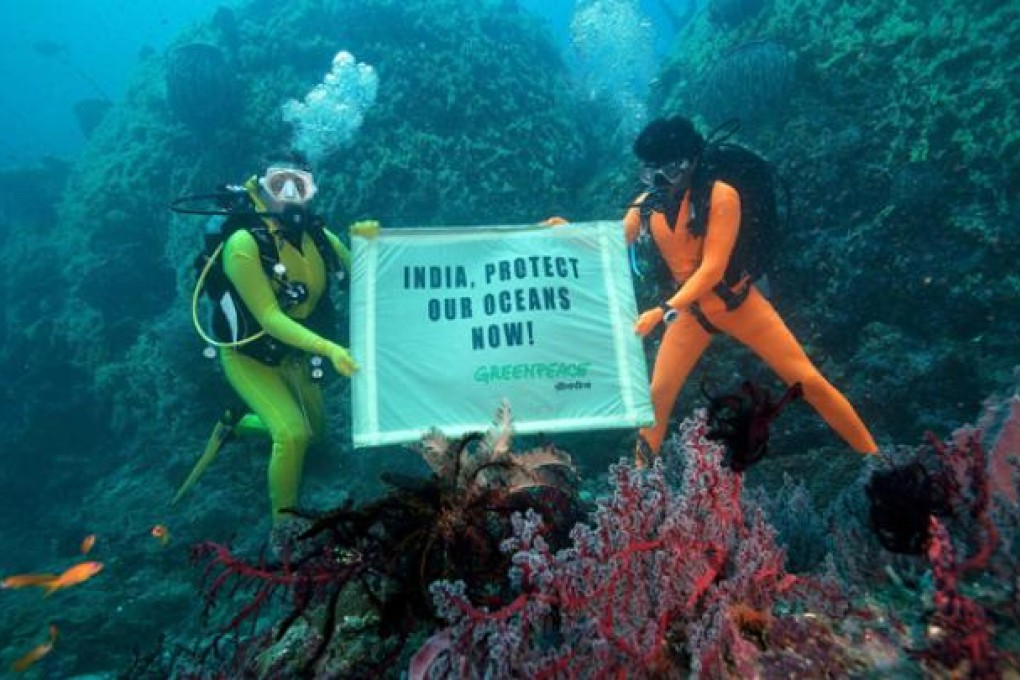Greenpeace divers off the coast of the Andaman and Nicobar islands send a message to the Indian government that they must protect the oceans and the communities whose livelihoods are dependent of the fruits of the seas. Photo: EPA