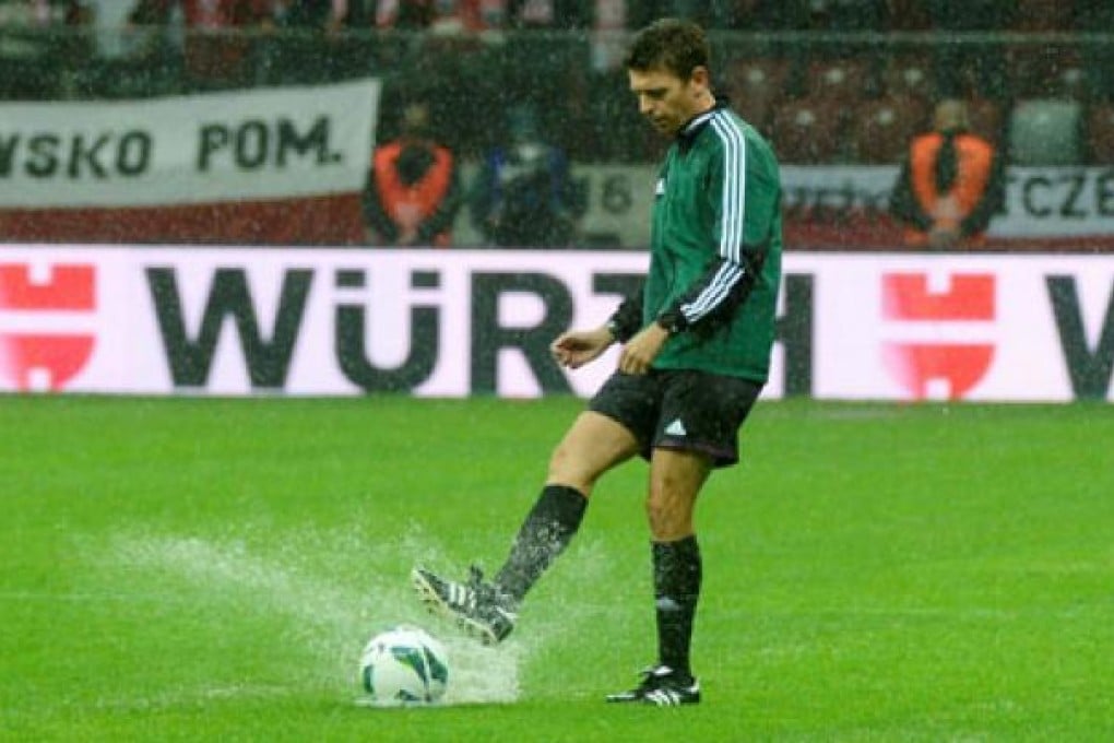 Italian referee Gianluca Rocchi test the pitch prior to the World Cup qualification match between Poland and England at the National Stadium in Warsaw, Poland, on Tuesday. Photo: EPA