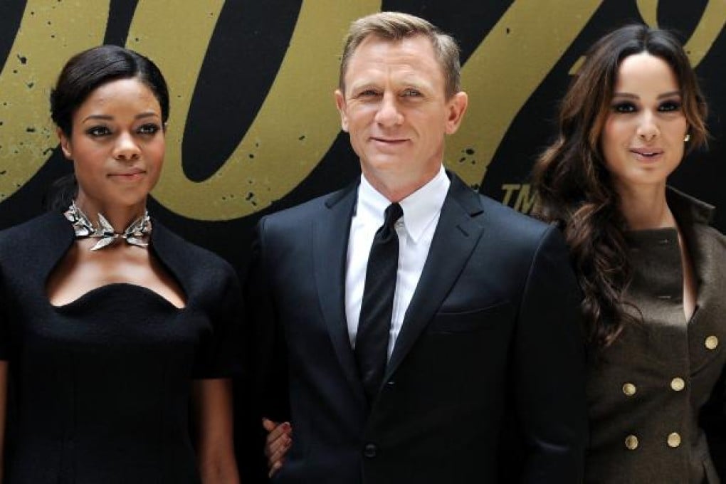 Daniel Craig, centre, with Naomie Harris, left, Berenice Marlohe during a photo call for "Skyfall" on October 15, 2012 in New York
