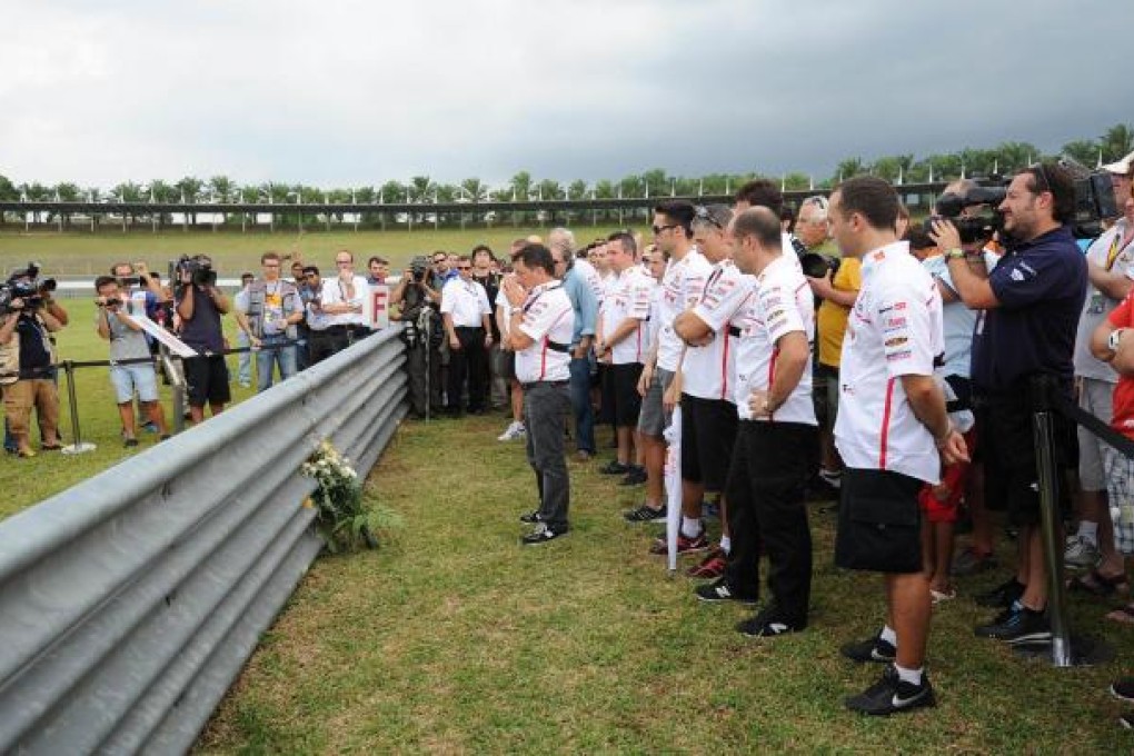 Honda team members pay tribute to Marco Simoncelli. Photo: AFP